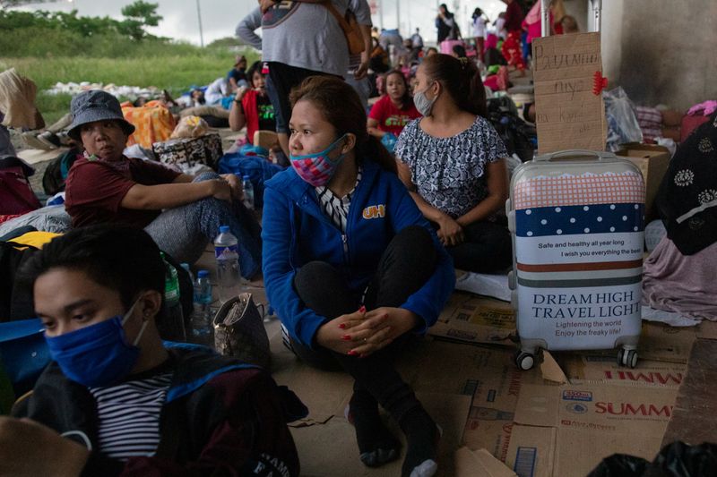 Hundreds of stranded passengers take shelter under an expressway near