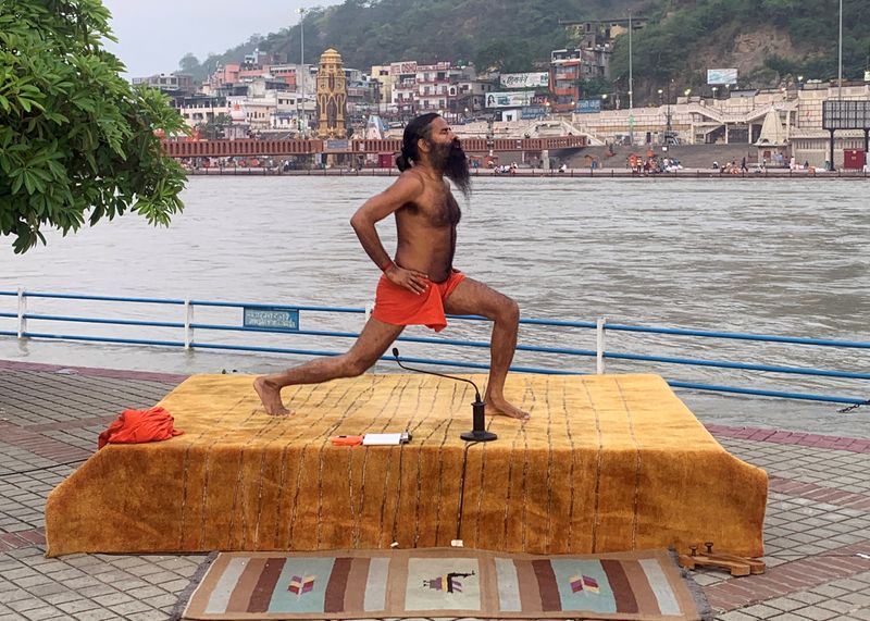 FILE PHOTO: India’s yoga guru Baba Ramdev performs yoga on