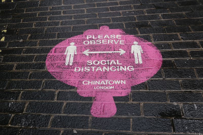 A sign displaying social distancing rules is displayed on the