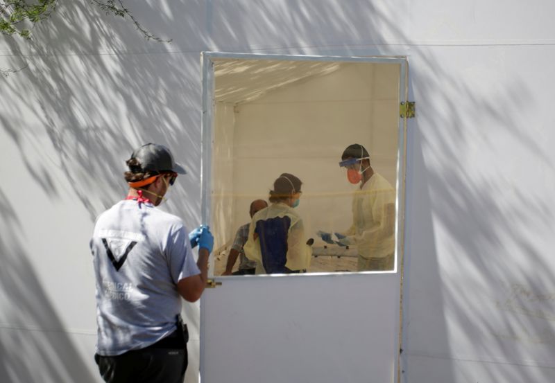 FILE PHOTO: Medical staff from Global Response Management takes samples