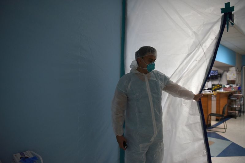FILE PHOTO:  A medical worker opens a makeshift door