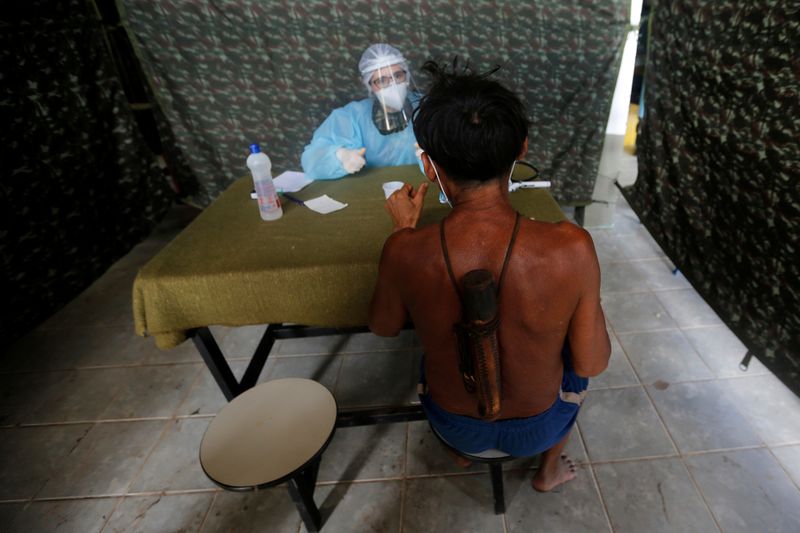 A member of Brazilian Armed Forces medical team examines a