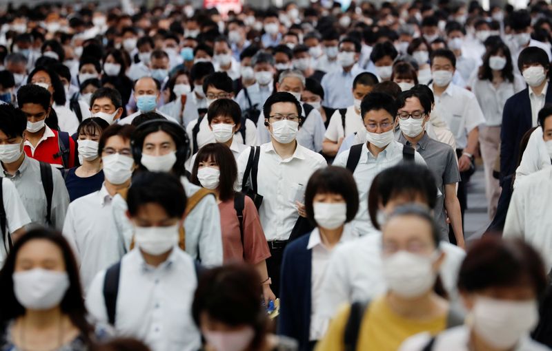 FILE PHOTO:  People wearing protective masks amid the coronavirus