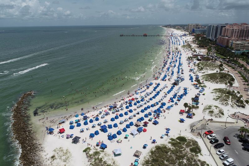 FILE PHOTO: Sun seekers gather at Clearwater Beach on Independence