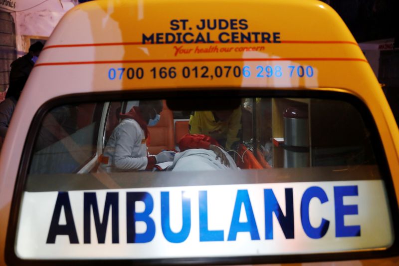 Medics examine a pregnant woman in an ambulance during the