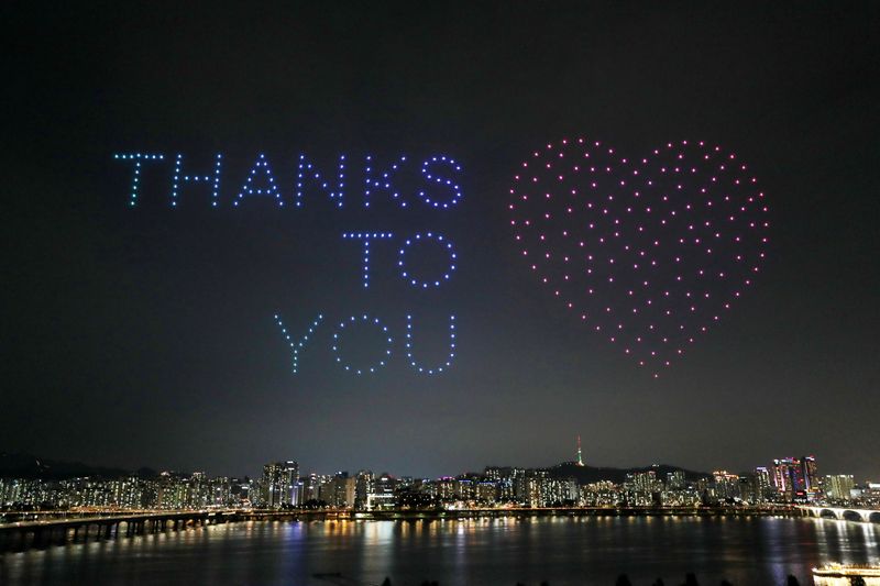 Drones fly over the Han river showing messages to support