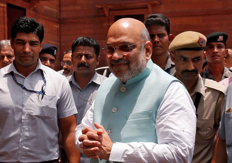 India’s newly appointed Home Minister Amit Shah greets the media