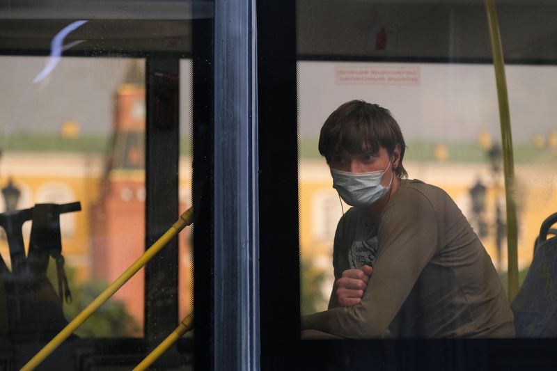 A passenger looks through a bus window in Moscow