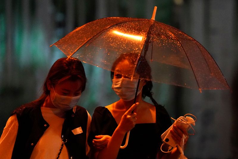 Women wearing masks following the coronavirus disease (COVID-19) outbreak walk