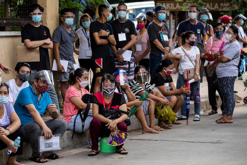 Filipinos queue for government aid amid the coronavirus disease (COVID-19)