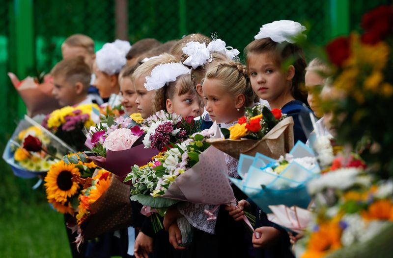 First graders attend a ceremony marking the start of the