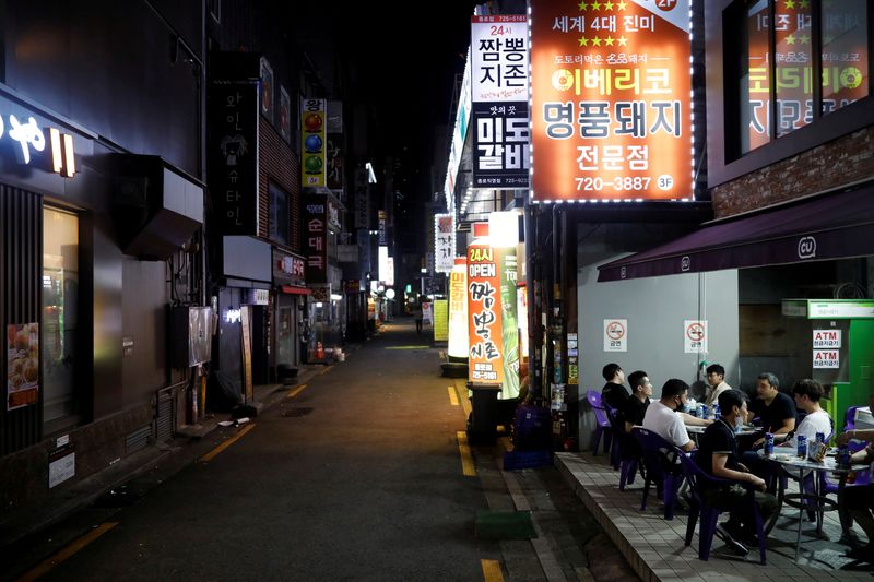 FILE PHOTO: People drink outside in Seoul as tougher social