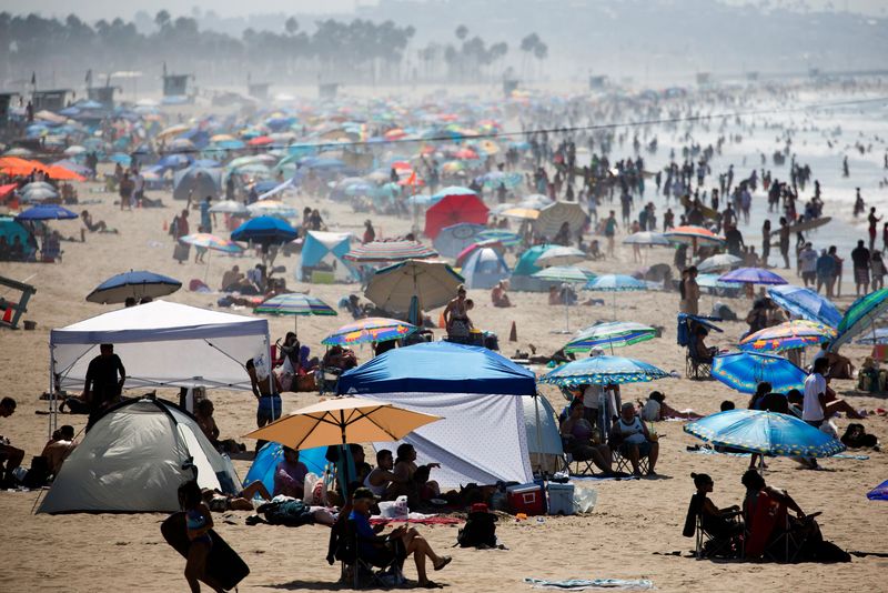 People crowd the beach on the record heat wave