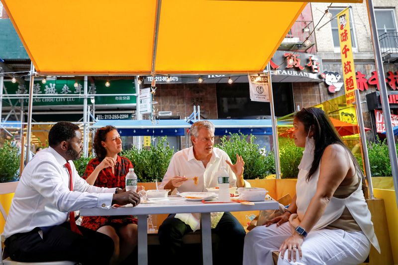 FILE PHOTO: New York City Mayor Bill de Blasio eats