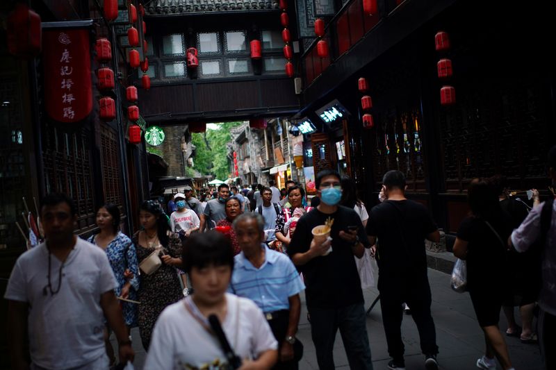 FILE PHOTO:  People walk on Jinli Ancient Street in