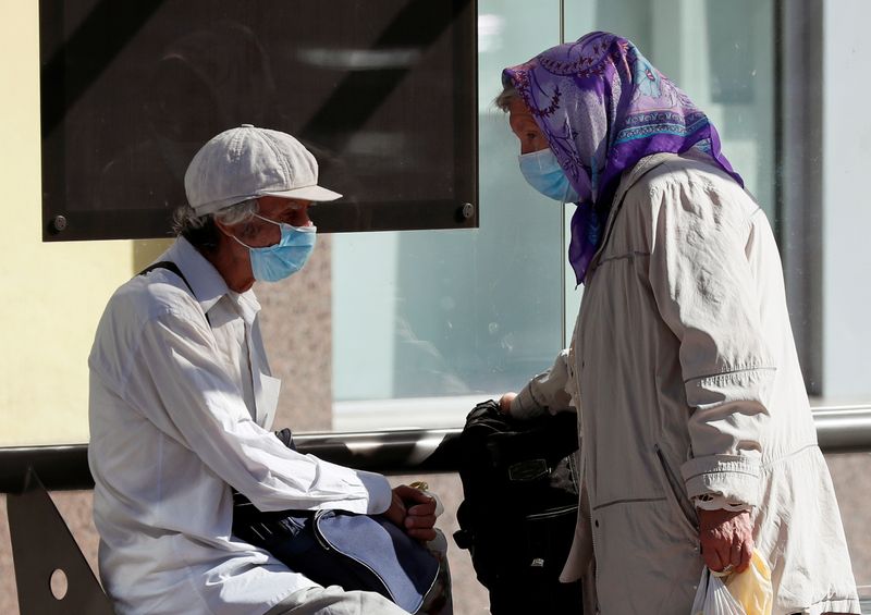 Elderly people wearing protective face masks are seen in central