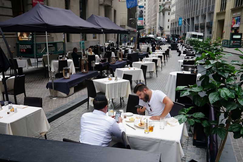 FILE PHOTO: People eat at a mostly empty restaurant with