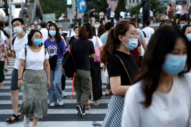 FILE PHOTO: People wearing face masks following the coronavirus disease