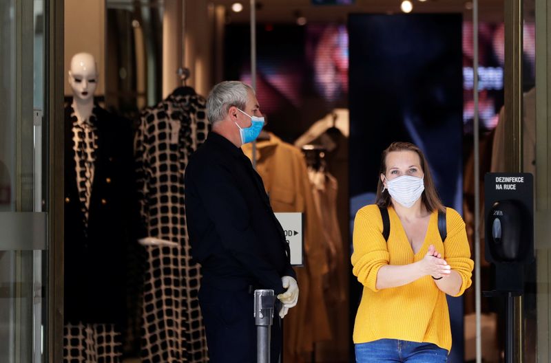 A woman wearing a face mask leaves a shopping mall