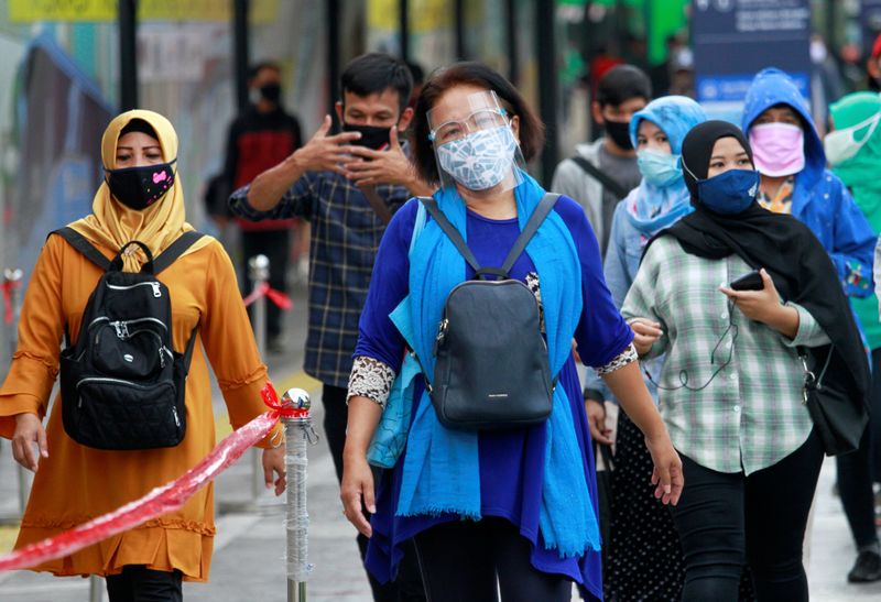 Passengers wear protective face masks at the Tanah Abang Station
