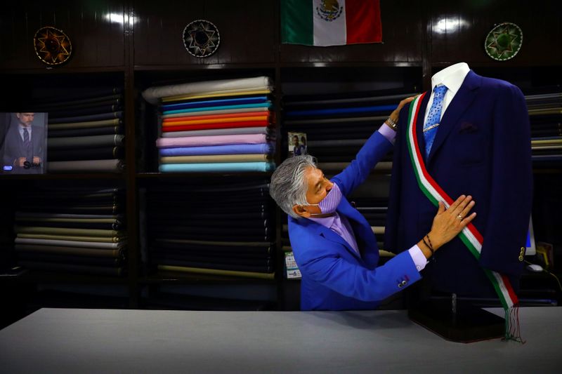 A vendor prepares a dress suit at Santana tailor shop,