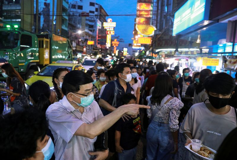 FILE PHOTO: People wear face masks after Thailand detected its