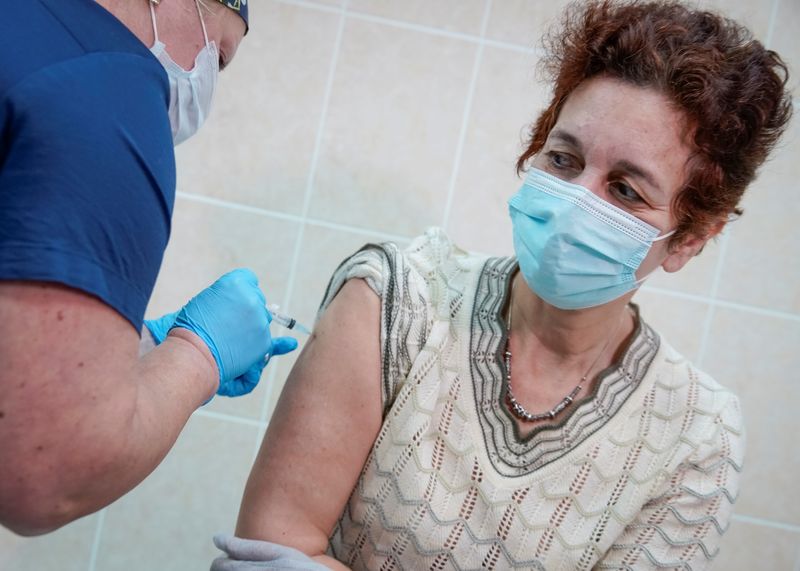 A nurse inoculates a volunteer with Russia’s “Sputnik-V” vaccine against