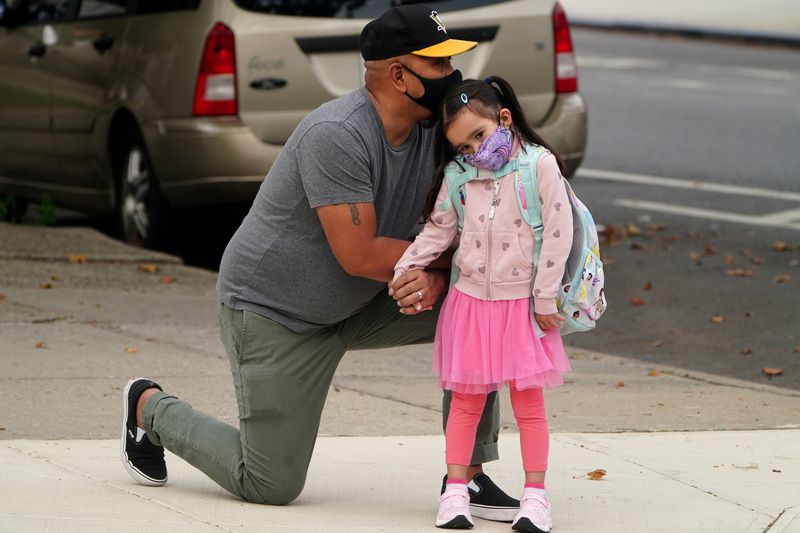 Joel Balcita comforts his daughter Sadie just before she attends