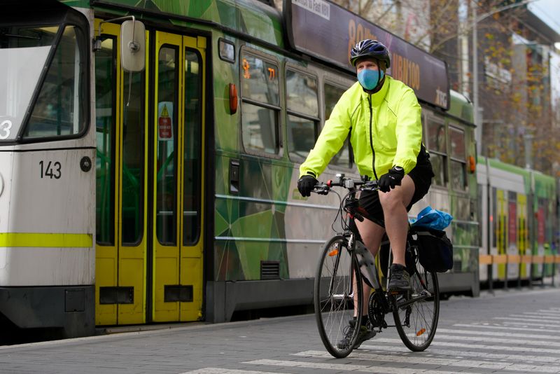 A cyclist wears a protective face mask in Melbourne, the