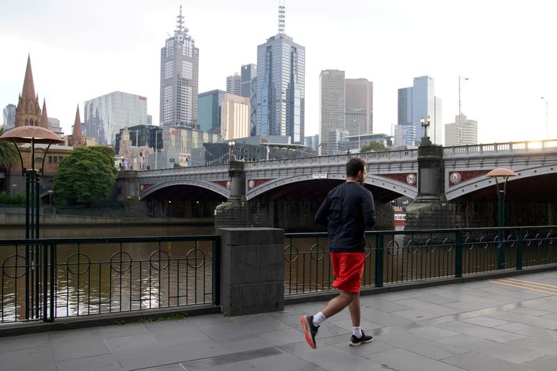 FILE PHOTO: A solitary man runs along a waterway under