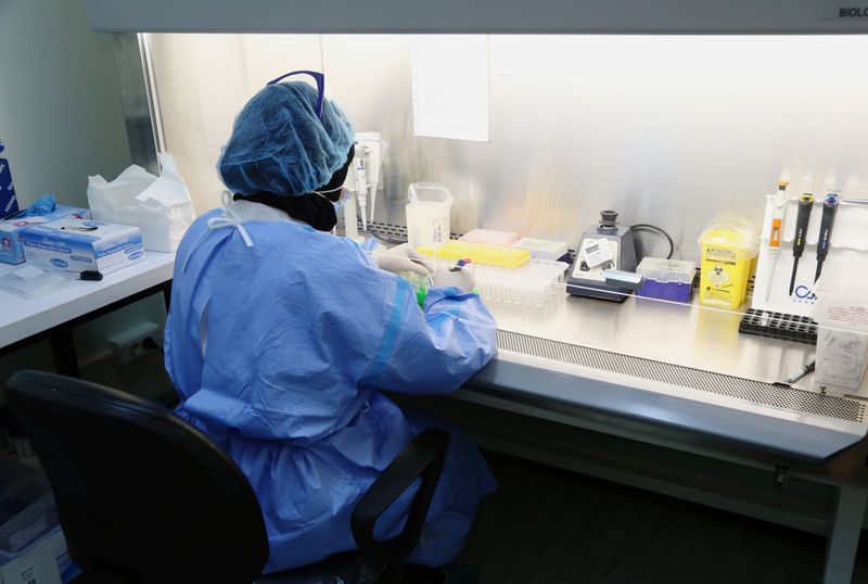 A medical staff works inside a lab for analysing the
