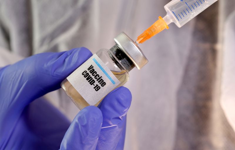 FILE PHOTO: A woman holds a small bottle labeled with