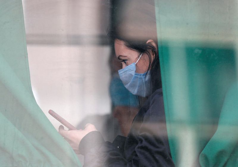 FILE PHOTO: A passenger wearing a protective face mask is