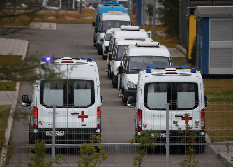 Ambulances are seen parked outside a hospital for patients infected