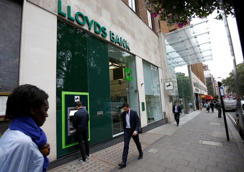 FILE PHOTO: People walk past a branch of Lloyds Bank