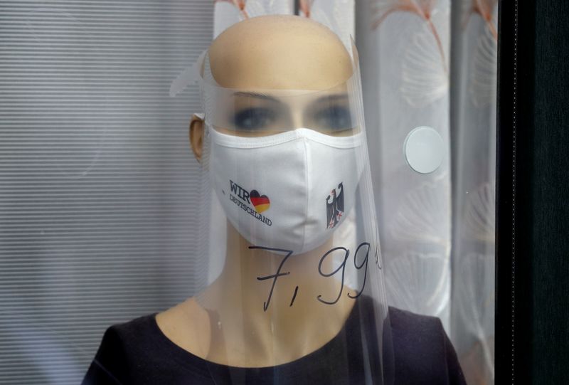 A mannequin wearing a protective mask is pictured at a