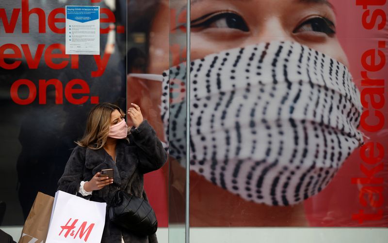 A woman wears a face mask as she stands outside