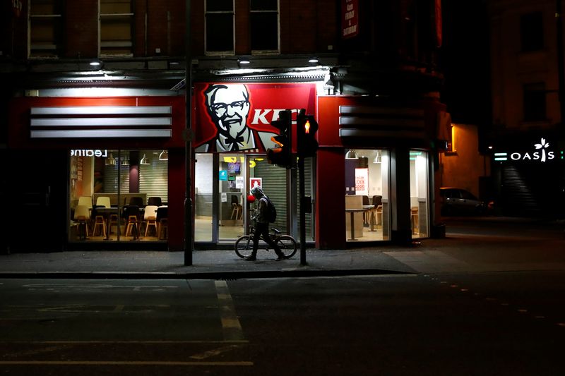 A person walks past an empty KFC restaurant in Belfast