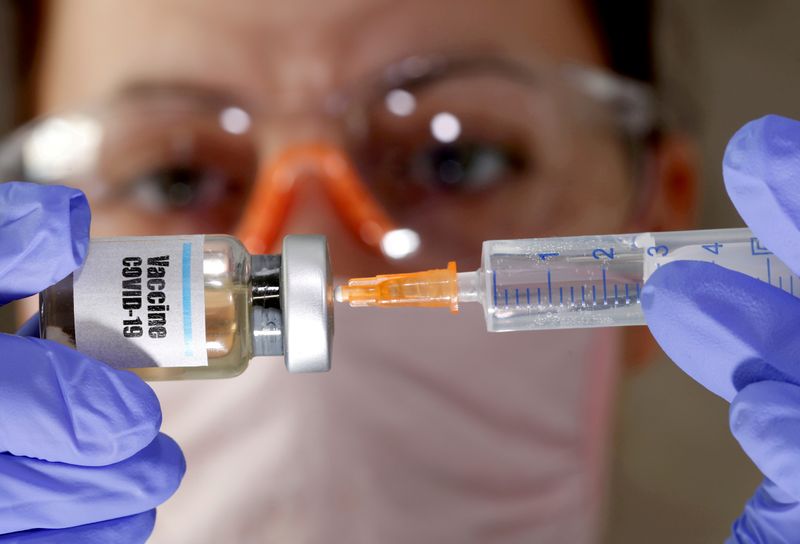 FILE PHOTO: A woman holds a small bottle labeled with
