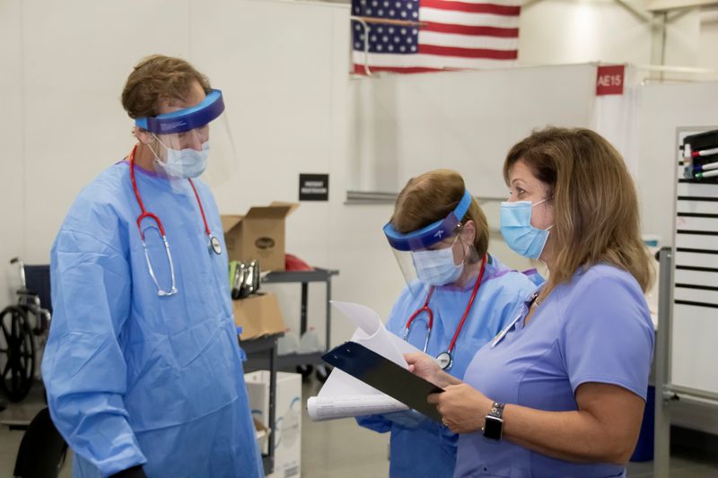 Medical personnel work inside a field hospital known as an