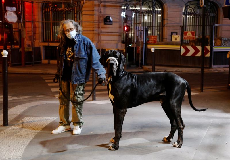 FILE PHOTO: A man walks his dog during the late-night
