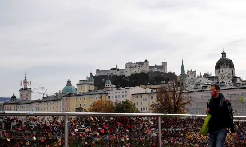 Man walks over a bridge in Salzburg