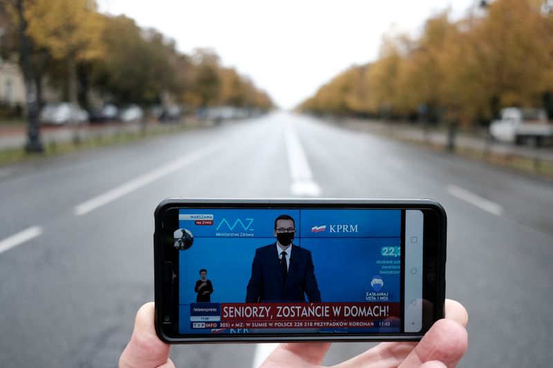 Poland’s Prime Minister Mateusz Morawiecki is seen on a mobile