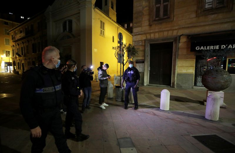 FILE PHOTO: Police officers check a person in Nice as