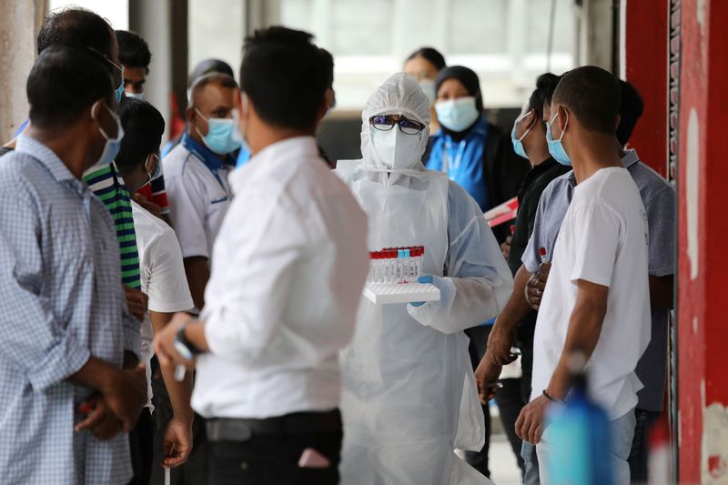 Medical worker prepares a coronavirus swab test outside a clinic