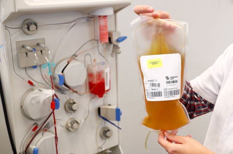 A nurse holds a bag of plasma from a recovered