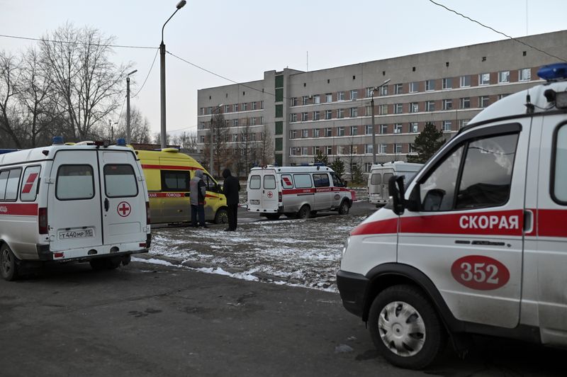 Ambulances are parked outside a hospital amid the outbreak of