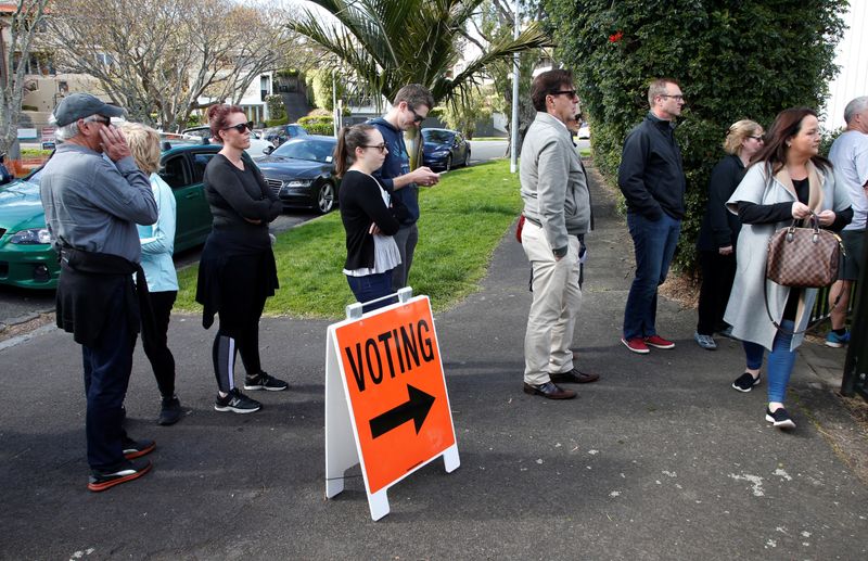 FILE PHOTO: Voters wait outside a polling station at the
