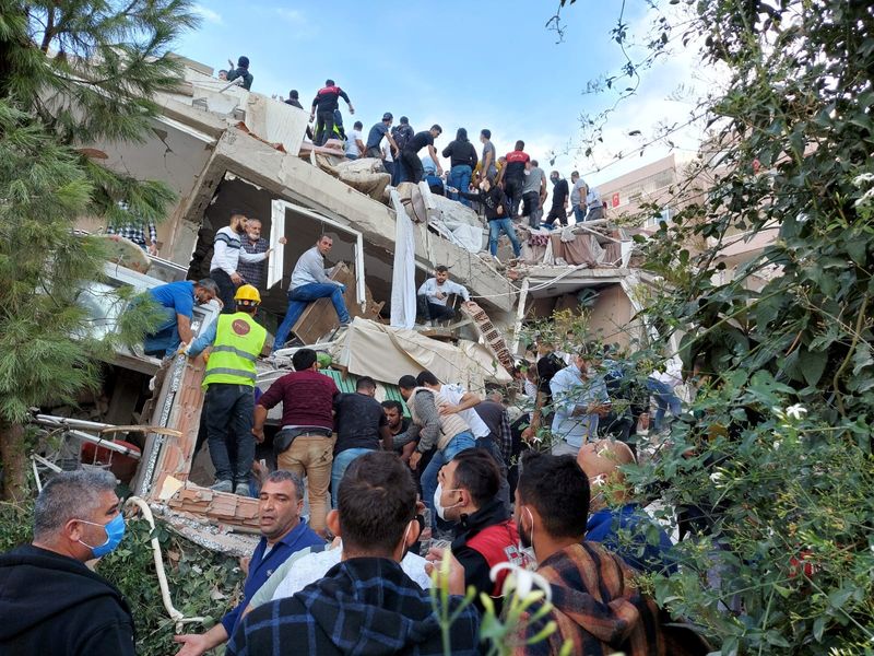 Locals and officials search for survivers at a collapsed building