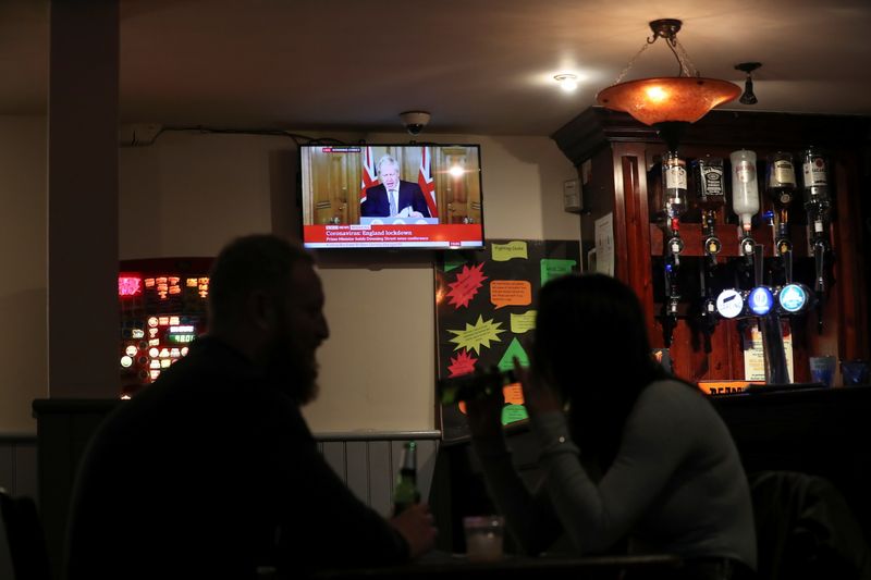 People talk inside a pub as Britain’s Prime Minister Boris